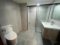 a bathroom with a toilet and a shower and a sink at Yawan Hotel in Wenquan