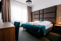 Łóżko lub łóżka w pokoju w obiekcie Hotel Delicjusz