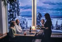 a group of people sitting at a table in a restaurant at Break Sokos Hotel Koli in Kolinkylä