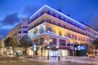 a large white building with a clock tower on a street at Best Western Hotel Lakmi Nice in Nice