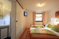 A bed or beds in a room at Migglwieshof