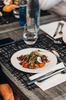 a plate of food on a table with a glass of water at Mercure Aix-en-Provence La Duranne Gare TGV in Aix-en-Provence