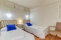 Postel nebo postele na pokoji v ubytování Ranchos Apartment