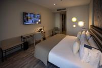 A bed or beds in a room at abba Sevilla