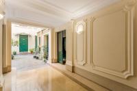 a hallway of a building with columns and green doors at Luxury 2 Bedroom 2,5 Bathroom Apartment - Champs Elysees in Paris