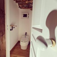 a small bathroom with a toilet and a door at Le monde d&#39;Echozellia in Saint-Germain-des-Champs