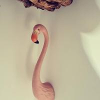 a fake pink flamingo is on a wall at Le monde d&#39;Echozellia in Saint-Germain-des-Champs