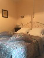 a bedroom with a bed with a white bedspread at Chambres d&#39;hôtes les Etoiles in Mareugheol