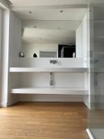 a kitchen with white cabinets and a mirror at CASA GUASCO superbe duplex au cœur de la Citadelle, vue à 360 in Bastia