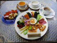 a plate of food on a table with a plate of food at Pulicity Villa B&amp;B in Puli