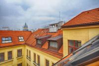 a group of buildings with orange roofs and a clock tower at Residence St Havel Prague Old Town in Prague