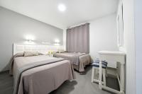 Posteľ alebo postele v izbe v ubytovaní Apartamentos Los Papagayos