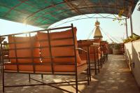 a row of chairs sitting under a roof at Hotel Bodhiz in Kathmandu