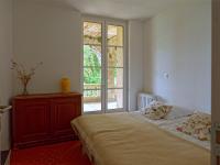 a bedroom with a bed and a large window at Gîte Marronnier in Tourrettes-sur-Loup
