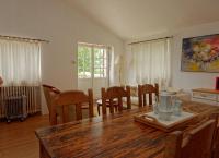 a kitchen and dining room with a wooden table and chairs at Gîte Marronnier in Tourrettes-sur-Loup