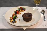 a plate of food with a chocolate cake and fruit at Dali Hôtel Perpignan - Restaurant in Perpignan