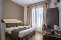 Łóżko lub łóżka w pokoju w obiekcie Hotel La Pergola