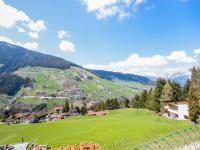 a view of a green hill with houses and a fence at Holiday Home Haselwanter by Interhome in Sellrain