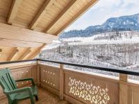 a room with a balcony with a view of snow covered mountains at Apartment Achtalgut-1 by Interhome in Lend