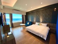 a bedroom with a bed and a view of the ocean at 36 Lighthouse in Hualien City