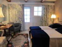 a bedroom with a bed and a desk and a window at Tertin Kartano in Mikkeli