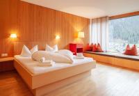 a bedroom with a large bed and a large window at Bonawinkel NEU in Gaschurn