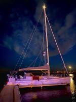 a boat is docked at a dock at night at SUPERBE VOILIER CAP AGDE avec parking gratuit sur place in Cap d&#39;Agde