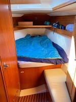 a bed in the cabin of a boat at SUPERBE VOILIER CAP AGDE avec parking gratuit sur place in Cap d&#39;Agde