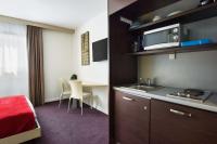 a hotel room with a kitchen and a bedroom at Sure Hotel by Best Western Nantes Beaujoire in Nantes