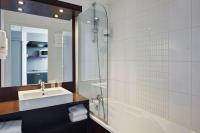 a bathroom with a sink and a tub and a mirror at Sure Hotel by Best Western Nantes Beaujoire in Nantes
