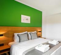A bed or beds in a room at Botanica Luxury Suites