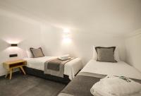 A bed or beds in a room at Botanica Luxury Suites