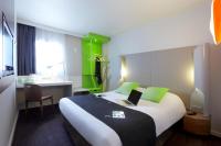 Una habitación de hotel con una cama y una computadora portátil encima. en Campanile Saint-Germain-En-Laye, en Saint-Germain-en-Laye