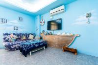 a blue room with a bed and a sink at Sunflower B&amp;B II in Hualien City