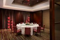 a dining room with a table with red chairs at Park Plaza Beijing Wangfujing in Beijing