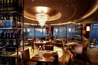 a restaurant with tables and chairs and a chandelier at Park Plaza Beijing Wangfujing in Beijing