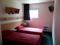 a hotel room with two beds and a window at Mister Bed Chambray Les Tours in Chambray-lès-Tours