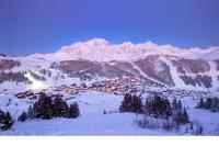 a small village in the snow with mountains in the background at Fasthotel Albertville in Albertville