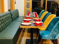 a long table with plates and red napkins on it at Hotel Alpine Musk in Kanatal