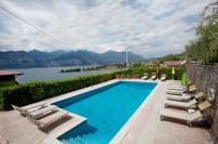 a swimming pool with lounge chairs and a view of a lake at Residence le Balze in Malcesine