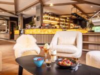 una mesa con un plato de comida y una silla en Novotel Megève Mont-Blanc, en Megève