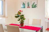a dining room table with a potted plant on it at SEA VIEW APARTMENT in Ližnjan