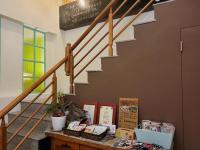a table in a room with a stairway with boxes on it at Slowly B&amp;B in Taitung City