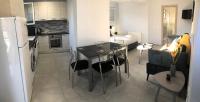 A kitchen or kitchenette at Strelitzia Apartments