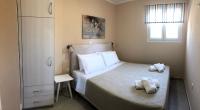 A bed or beds in a room at Strelitzia Apartments