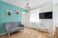 Televízia a/alebo spoločenská miestnosť v ubytovaní APARTAMENT RODZINNY