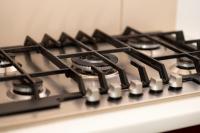 a gas stove top with black burners on it at Huize Porteman in Staden