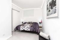 A bed or beds in a room at Manuda Luxury Apartment