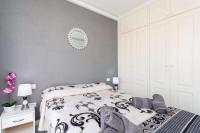 A bed or beds in a room at Manuda Luxury Apartment