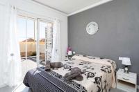 A bed or beds in a room at Manuda Luxury Apartment